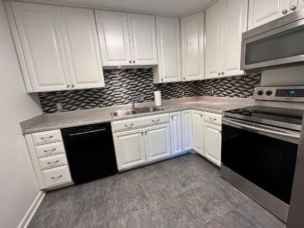 854 Todd Preis Dr, Nashville, TN 37221 - kitchen featuring a sink, light countertops, white cabinets, and stainless steel appliances
