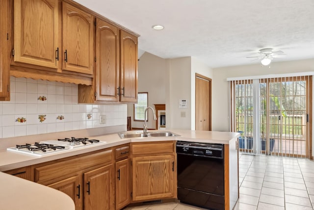 kitchen featuring white gas cooktop, a peninsula, a sink, light countertops, and dishwasher