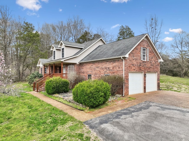 view of property exterior with roof with shingles, an attached garage, covered porch, aphalt driveway, and brick siding