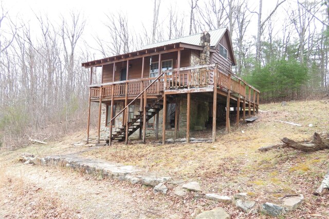 exterior space with metal roof and stairs