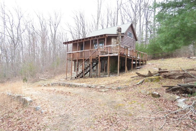 view of front of home featuring stairs and metal roof