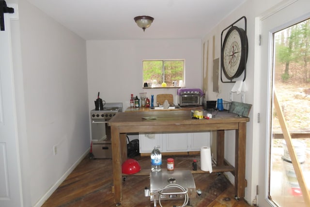 dining space featuring dark wood-style floors and baseboards