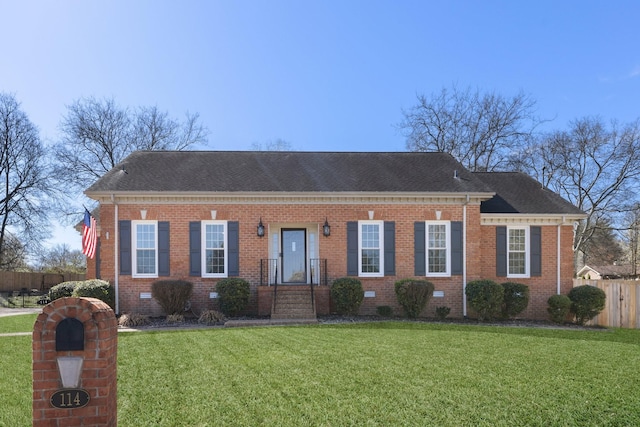 view of front of house with a front lawn, fence, brick siding, and a shingled roof