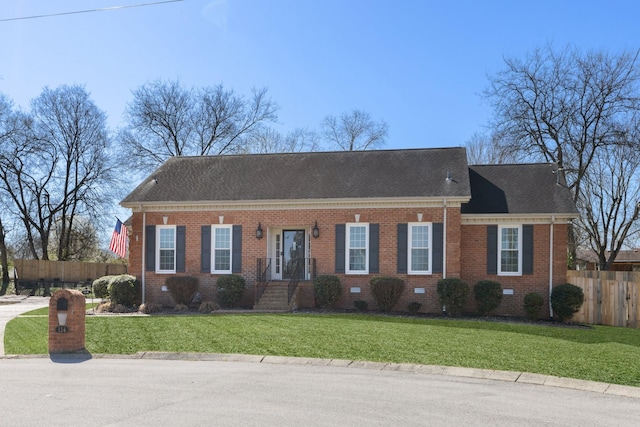view of front of home featuring a front lawn, fence, brick siding, and a shingled roof