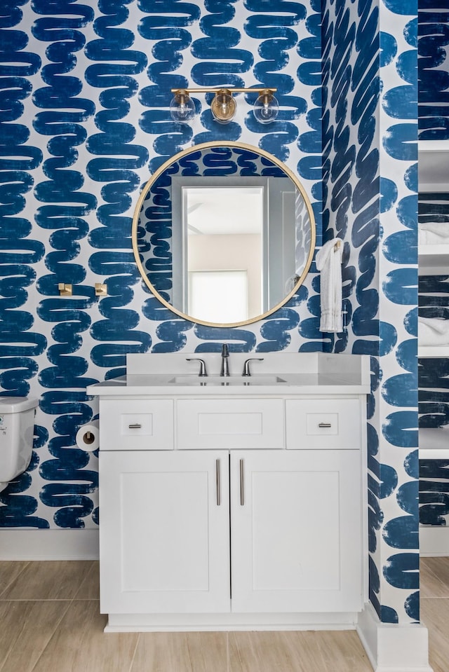 bathroom featuring toilet and vanity