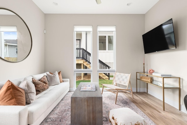 living area with wood finished floors, baseboards, and plenty of natural light