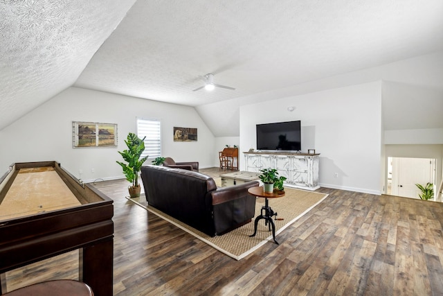 living room featuring a textured ceiling, baseboards, ceiling fan, wood finished floors, and vaulted ceiling