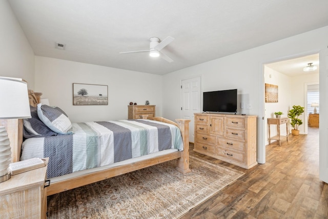 bedroom featuring visible vents, wood finished floors, and ceiling fan