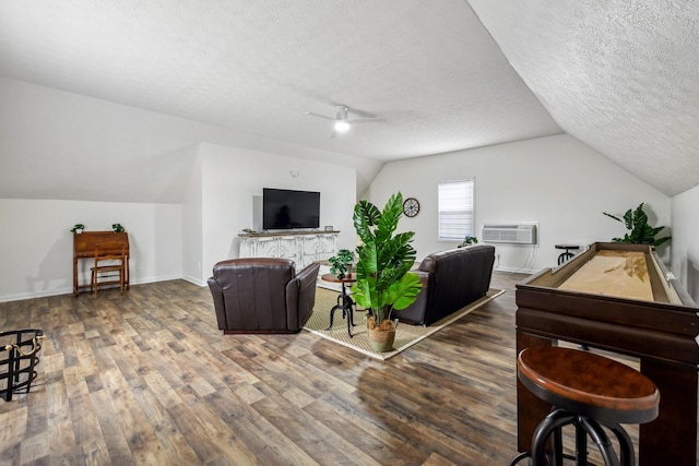 living area with a ceiling fan, a wall unit AC, wood finished floors, a textured ceiling, and lofted ceiling