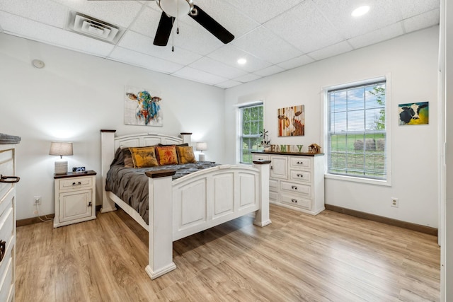bedroom featuring light wood finished floors, baseboards, and visible vents