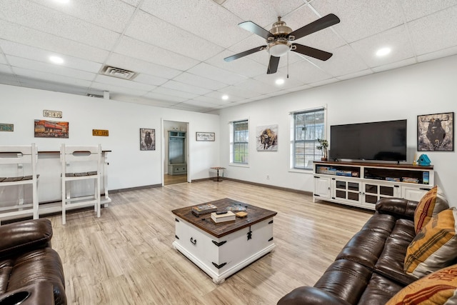 living room featuring a paneled ceiling, light wood-style floors, and a ceiling fan