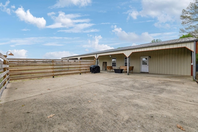 back of house featuring a carport