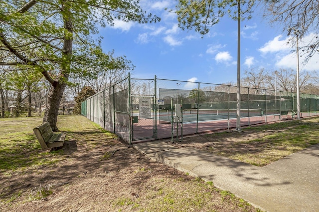 view of tennis court with fence and a gate