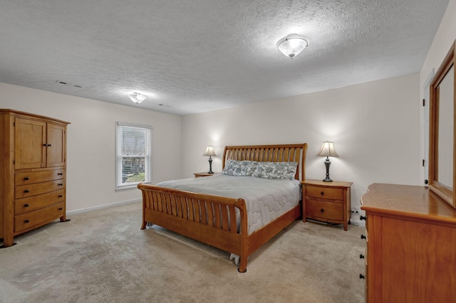 bedroom with light carpet, visible vents, a textured ceiling, and baseboards