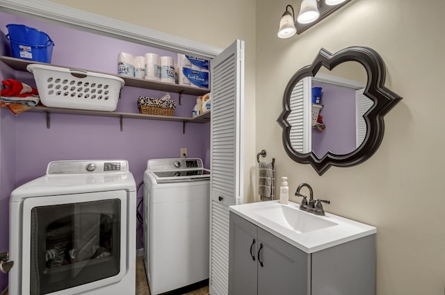 laundry room with laundry area, independent washer and dryer, and a sink