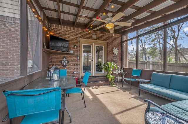 sunroom / solarium with an outdoor living space, french doors, and ceiling fan