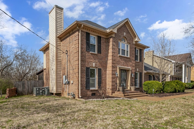 view of front of home featuring brick siding, fence, central AC, a front yard, and a chimney