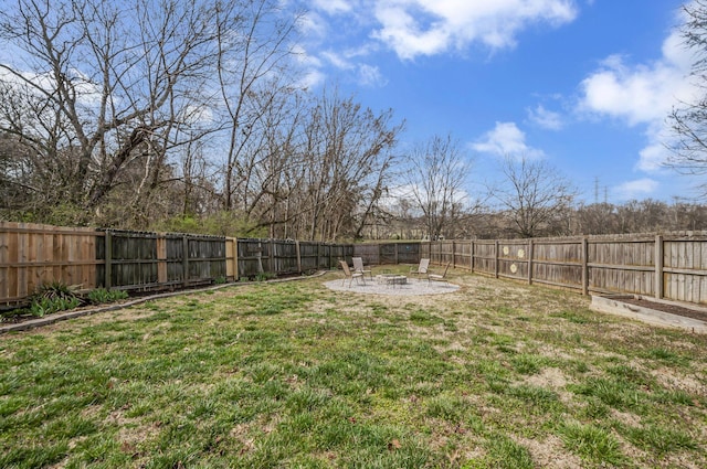 view of yard featuring a patio area, a fenced backyard, and an outdoor fire pit