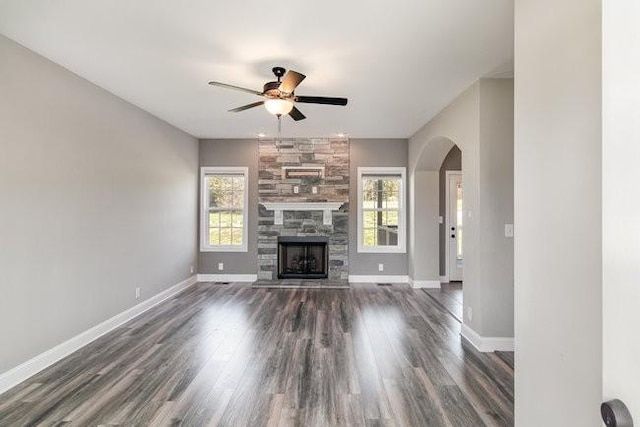 1033 Garner Hills Dr, Clarksville, TN 37042 - unfurnished living room with arched walkways, a healthy amount of sunlight, baseboards, and a ceiling fan