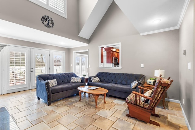 living area featuring baseboards, a high ceiling, and ornamental molding