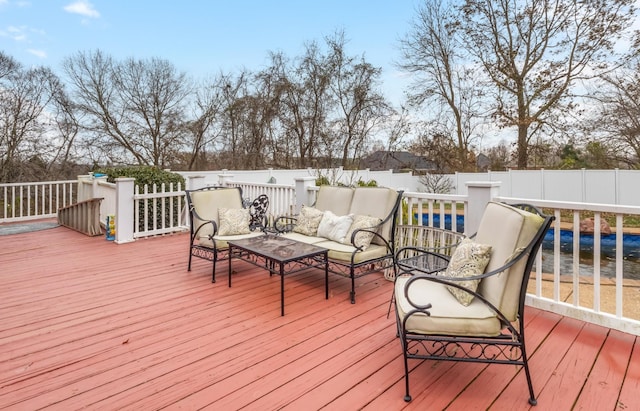 wooden terrace featuring an outdoor hangout area and a fenced backyard