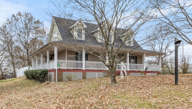 farmhouse inspired home featuring covered porch and a shingled roof