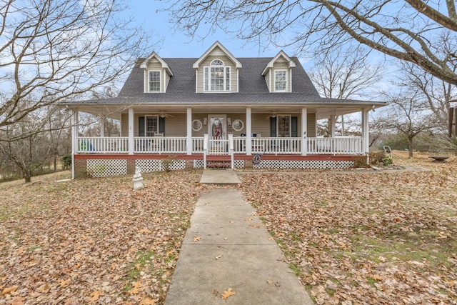 farmhouse-style home with covered porch and a shingled roof