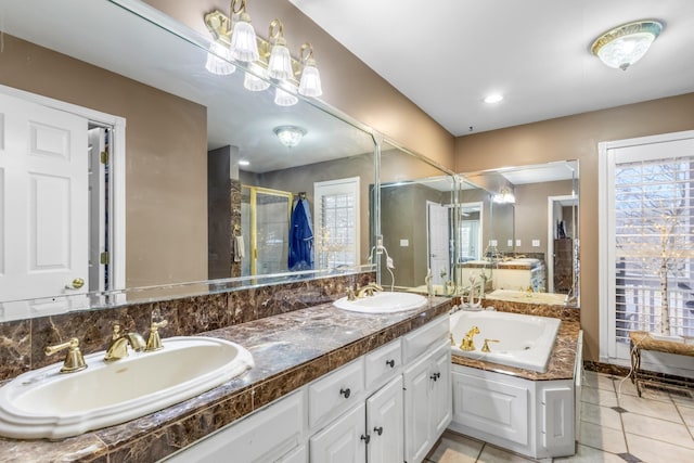 bathroom with a shower stall, a garden tub, tile patterned floors, and a sink
