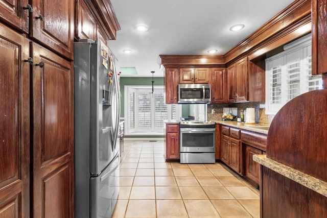 kitchen featuring pendant lighting, tasteful backsplash, recessed lighting, stainless steel appliances, and light tile patterned floors