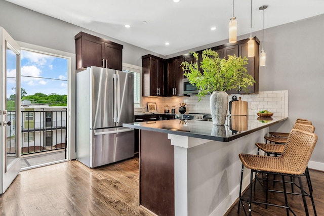 2003 Convent Pl Unit 6, Nashville, TN 37212 - kitchen featuring stainless steel appliances, dark brown cabinets, tasteful backsplash, wood finished floors, and recessed lighting