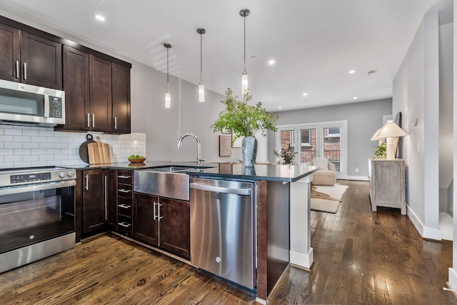 2003 Convent Pl Unit 6, Nashville, TN 37212 - kitchen featuring appliances with stainless steel finishes, a sink, a peninsula, dark wood-style floors, and open floor plan