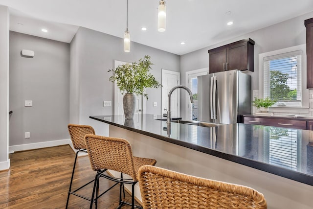 2003 Convent Pl Unit 6, Nashville, TN 37212 - kitchen with freestanding refrigerator, dark countertops, a sink, a kitchen breakfast bar, and dark wood finished floors