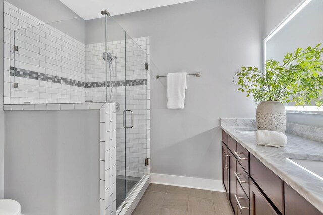 2003 Convent Pl Unit 6, Nashville, TN 37212 - full bathroom featuring a shower stall, double vanity, and baseboards