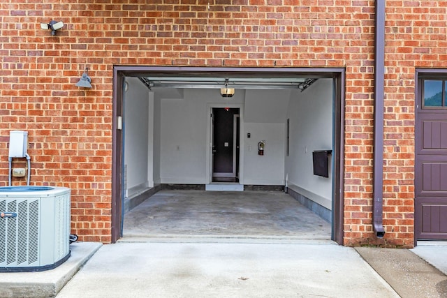 2003 Convent Pl Unit 6, Nashville, TN 37212 - doorway to property with central AC unit, brick siding, and a garage