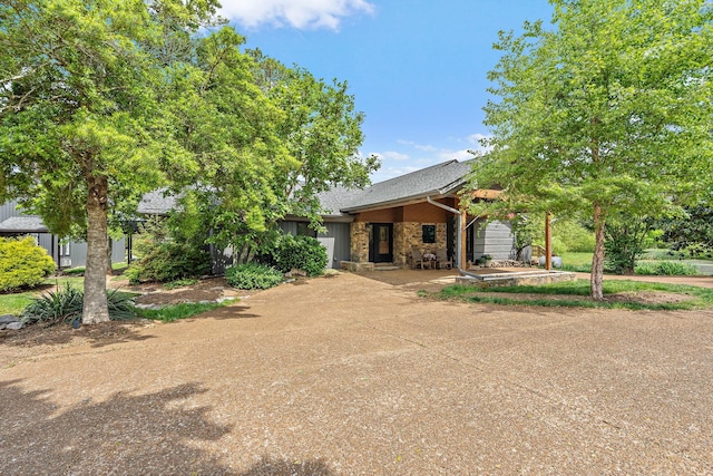 6923 Cross Keys Rd, College Grove, TN 37046 - view of front of house with roof with shingles, a garage, stone siding, and driveway