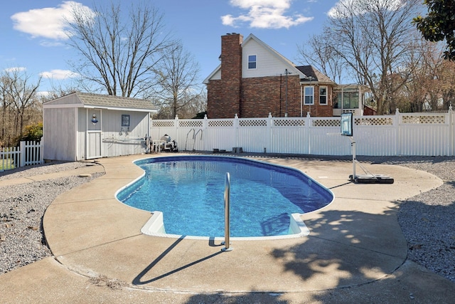 view of pool with an exterior structure, a fenced backyard, and an outdoor structure