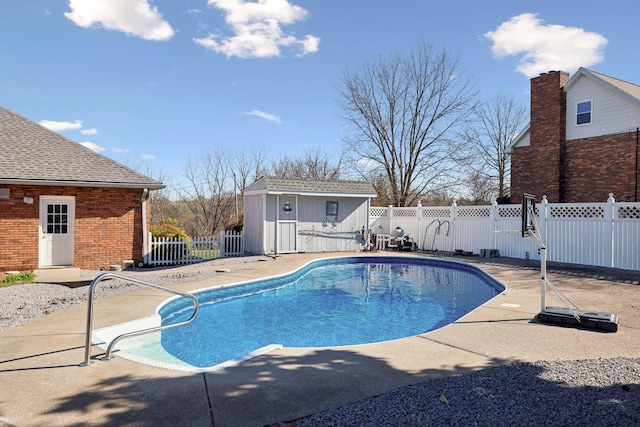 view of pool with an outbuilding, a fenced in pool, a patio, and fence
