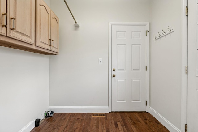 laundry room featuring baseboards and dark wood-style flooring
