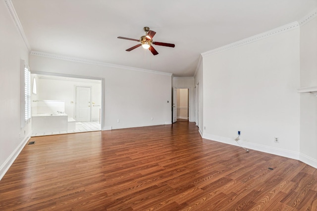 spare room featuring ornamental molding, baseboards, ceiling fan, and wood finished floors