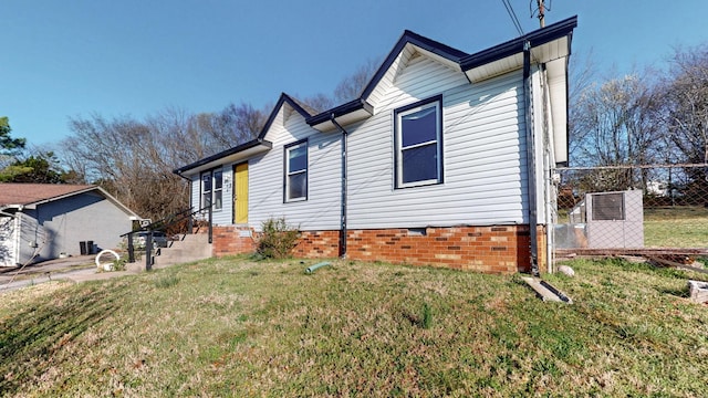 view of home's exterior featuring crawl space, a yard, and fence