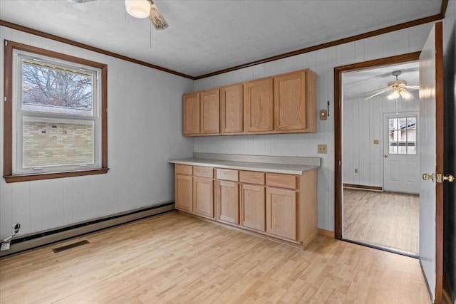 kitchen with light countertops, light wood-style floors, ceiling fan, and a baseboard radiator