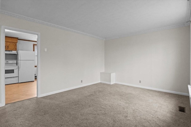 carpeted empty room with crown molding, baseboards, and visible vents