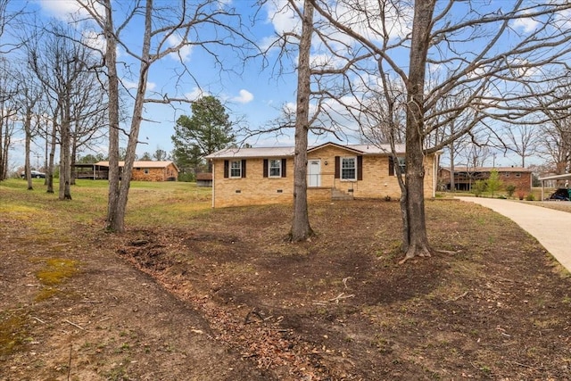 ranch-style home featuring crawl space and concrete driveway