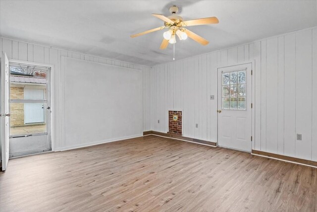 spare room with wood finished floors, baseboards, and ceiling fan
