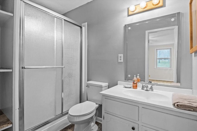 full bathroom with a shower stall, toilet, and vanity