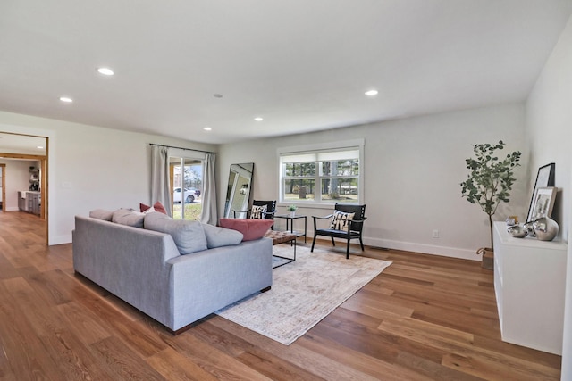 living room with recessed lighting, wood finished floors, and baseboards