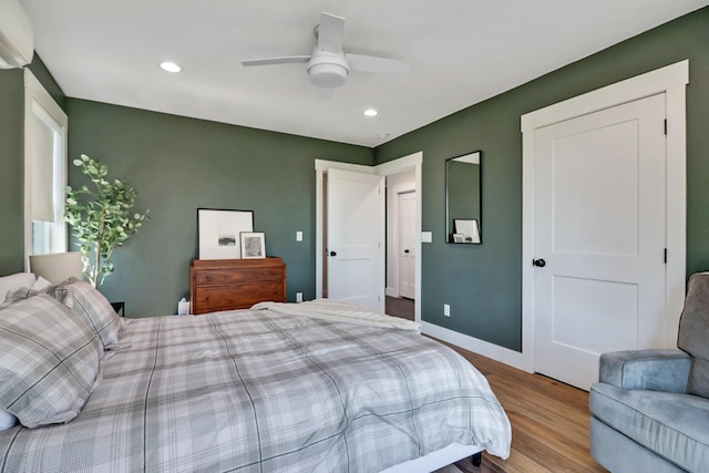 bedroom with a ceiling fan, recessed lighting, wood finished floors, and baseboards