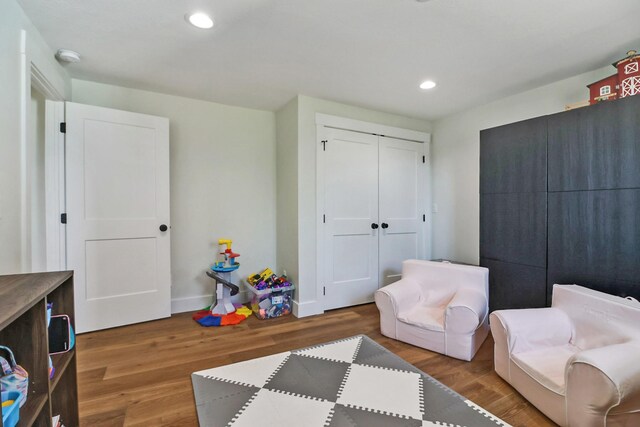 interior space featuring recessed lighting, baseboards, and wood finished floors