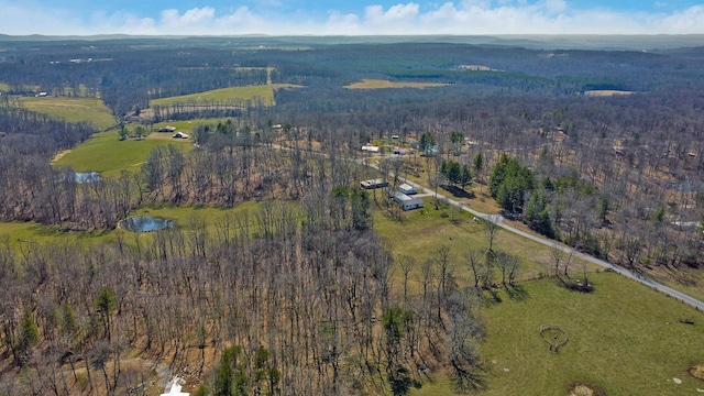 drone / aerial view featuring a forest view