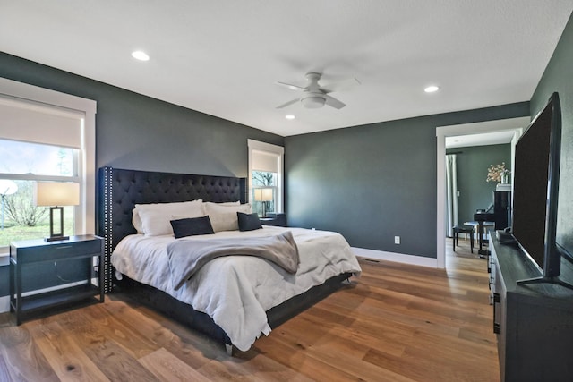 bedroom featuring recessed lighting, wood finished floors, and baseboards